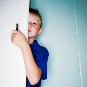 Boy behind door